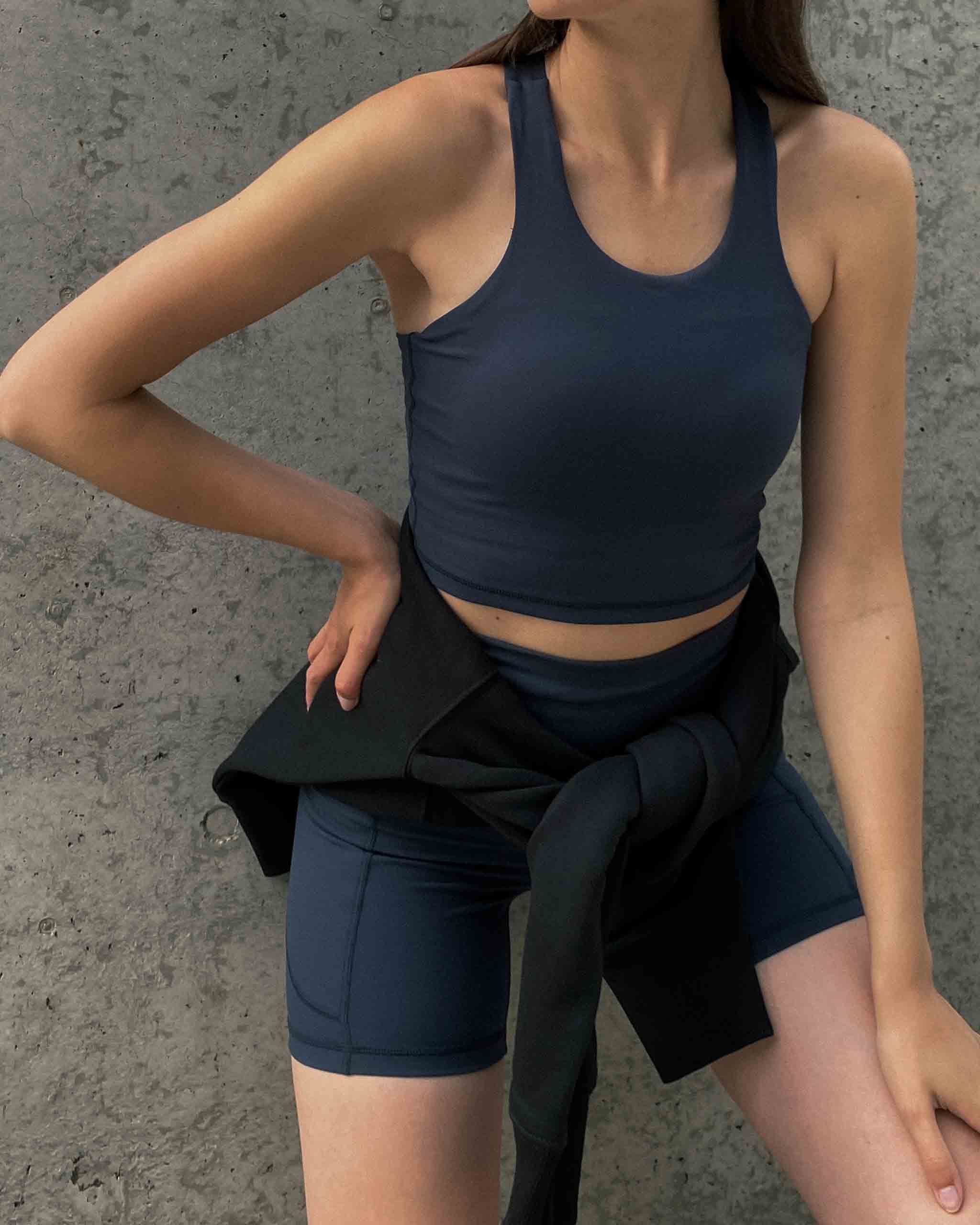 Woman posing in ninepine activewear shorts and tank top
